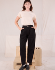Alex is 5’8” and wearing XXS Heritage Trousers in Basic Black paired with Organic Vintage Tee in vintage tee off-white