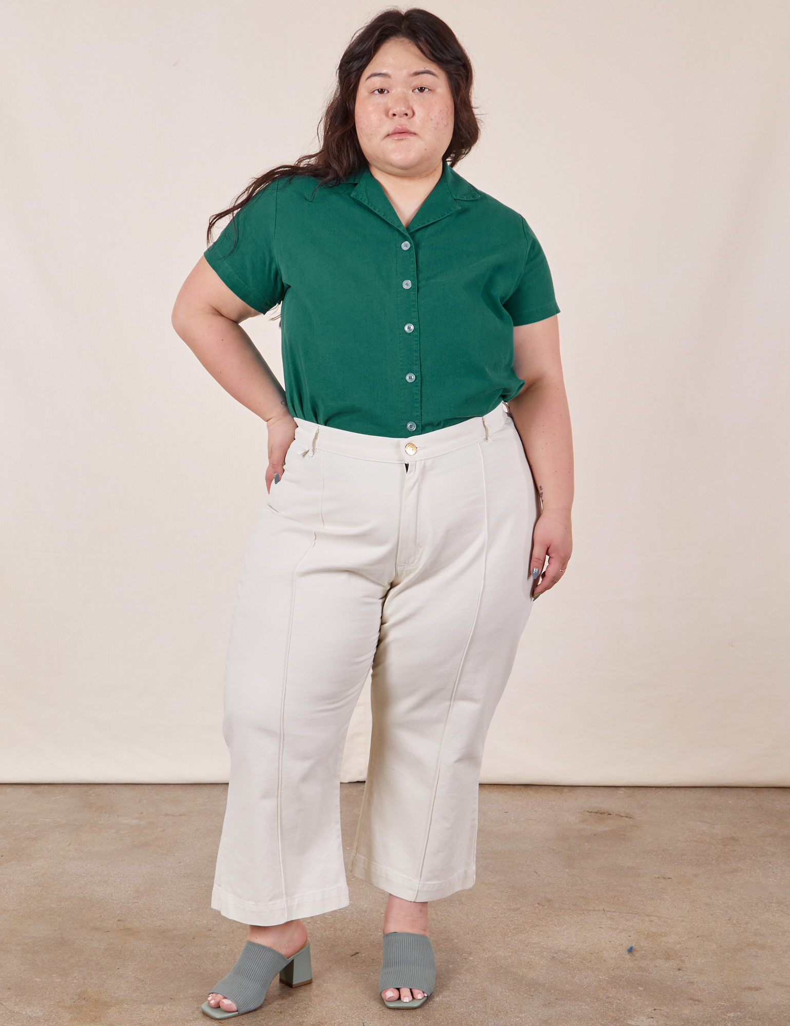 Ashley is wearing Pantry Button-Up in Hunter Green tucked into vintage tee off-white Petite Western Pants