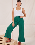 Tiara is 5'4" and wearing XS Bell Bottoms in Hunter Green paired with vintage off-white Cropped Tank Top
