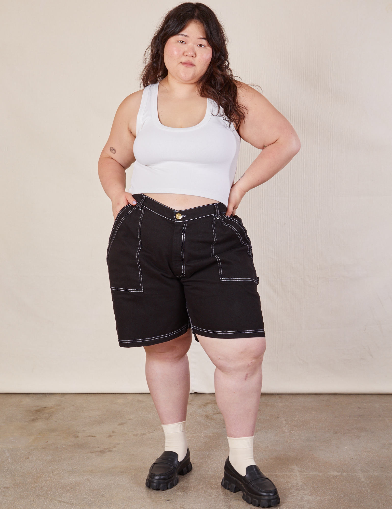 Ashley is wearing Carpenter Shorts in Basic Black and Cropped Tank in vintage tee off-white