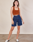 Alex is 5'8" and wearing XXS Carpenter Shorts in Dark Wash paired with burnt terracotta Cropped Tank
