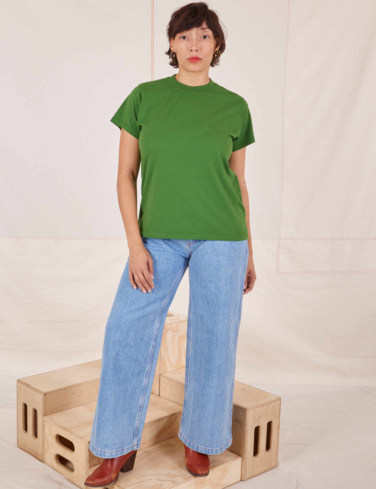 Tiara is wearing Organic Vintage Tee in Lawn Green and light wash Sailor Jeans