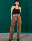 Tiara is 5'4" and wearing S Leopard Work Pants paired with black Halter Top