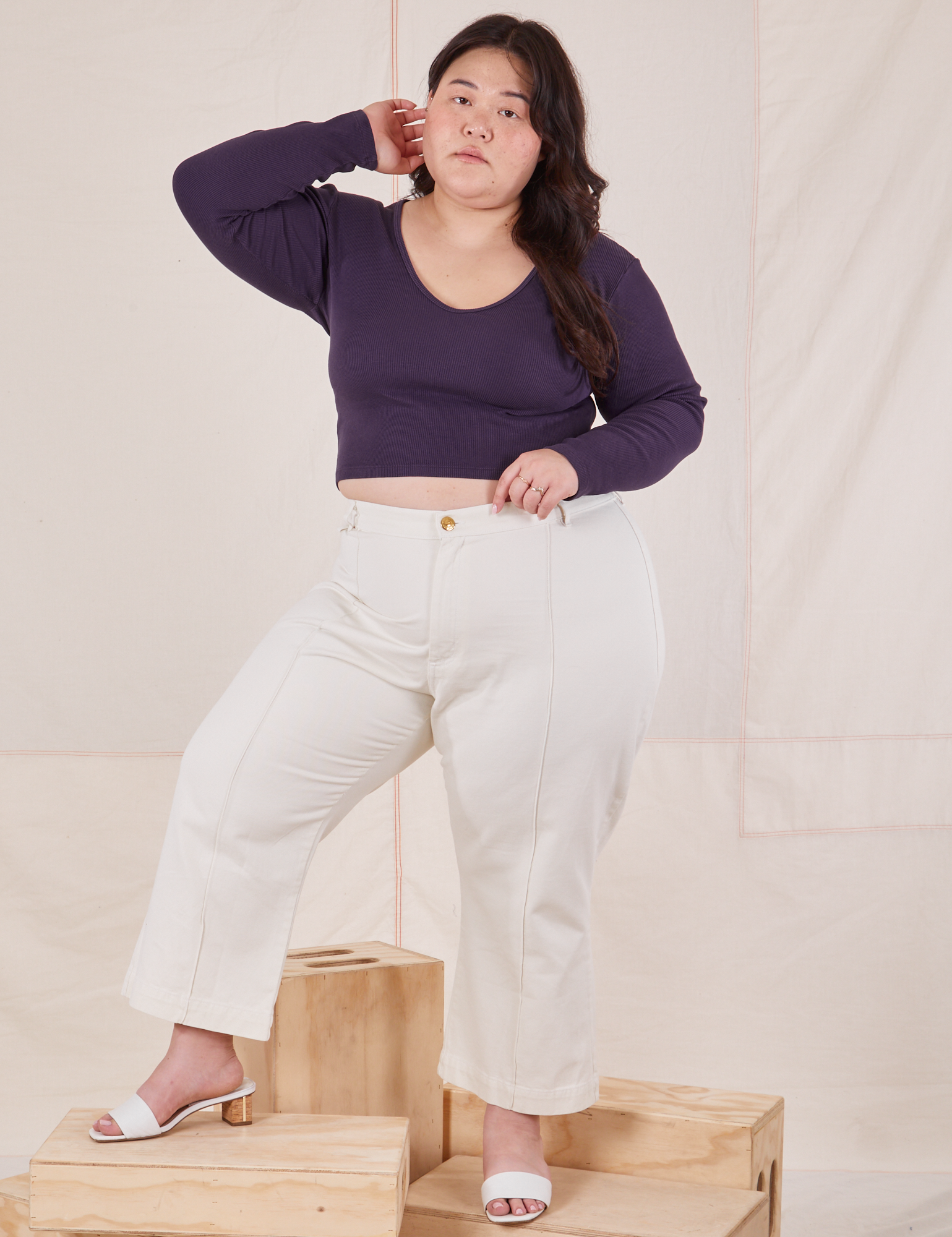 Ashley is wearing Long Sleeve V-Neck Tee in Nebula Purple and vintage tee off-white Petite Western Pants