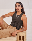 Anthony is wearing Racerback Tank in Espresso Brown and tan Western Pants