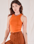 Alex is 5’8” and wearing P Racerback Tank in Sunset Orange