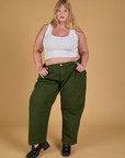 Juliet is wearing Baggy Mid-Rise Trousers in Evergreen and vintage tee white Cropped Tank
