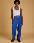 Jerrod is wearing Baggy Mid-Rise Trousers in Royal Blue and vintage tee white Cropped Tank