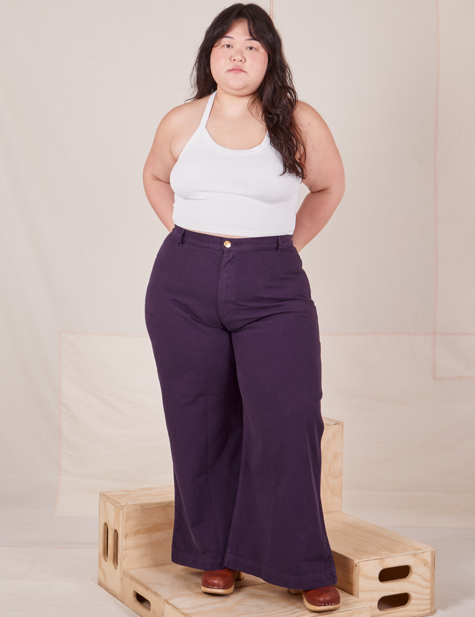 Ashley is wearing Bell Bottoms in Nebula Purple and Halter Top in vintage tee off-white