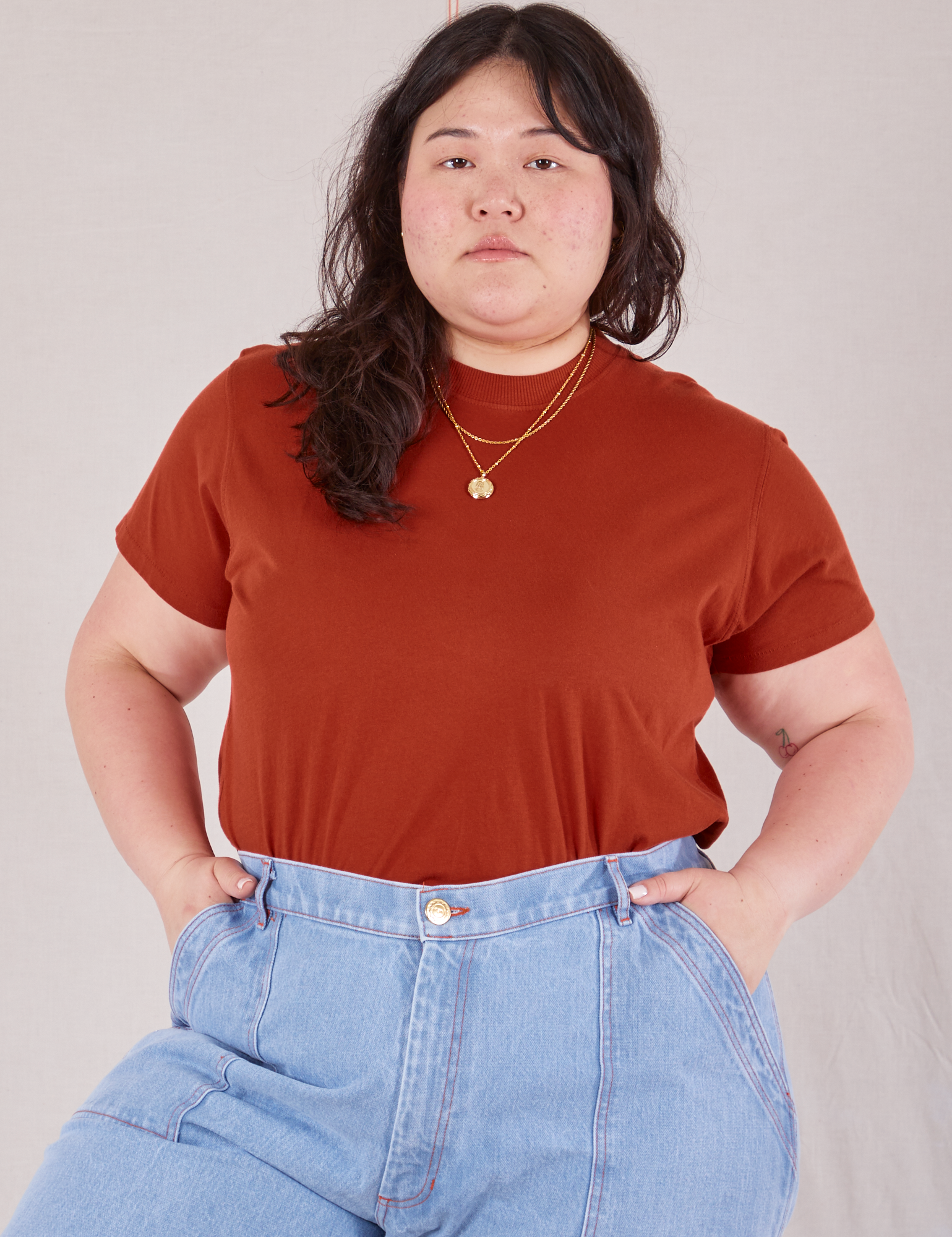 Ashley is wearing Organic Vintage Tee in Paprika tucked into light wash Carpenter Jeans