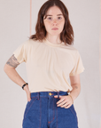 Hana is 5'3" and wearing P Organic Vintage Tee in Vintage Tee Off-White tucked into dark wash Carpenter Jeans