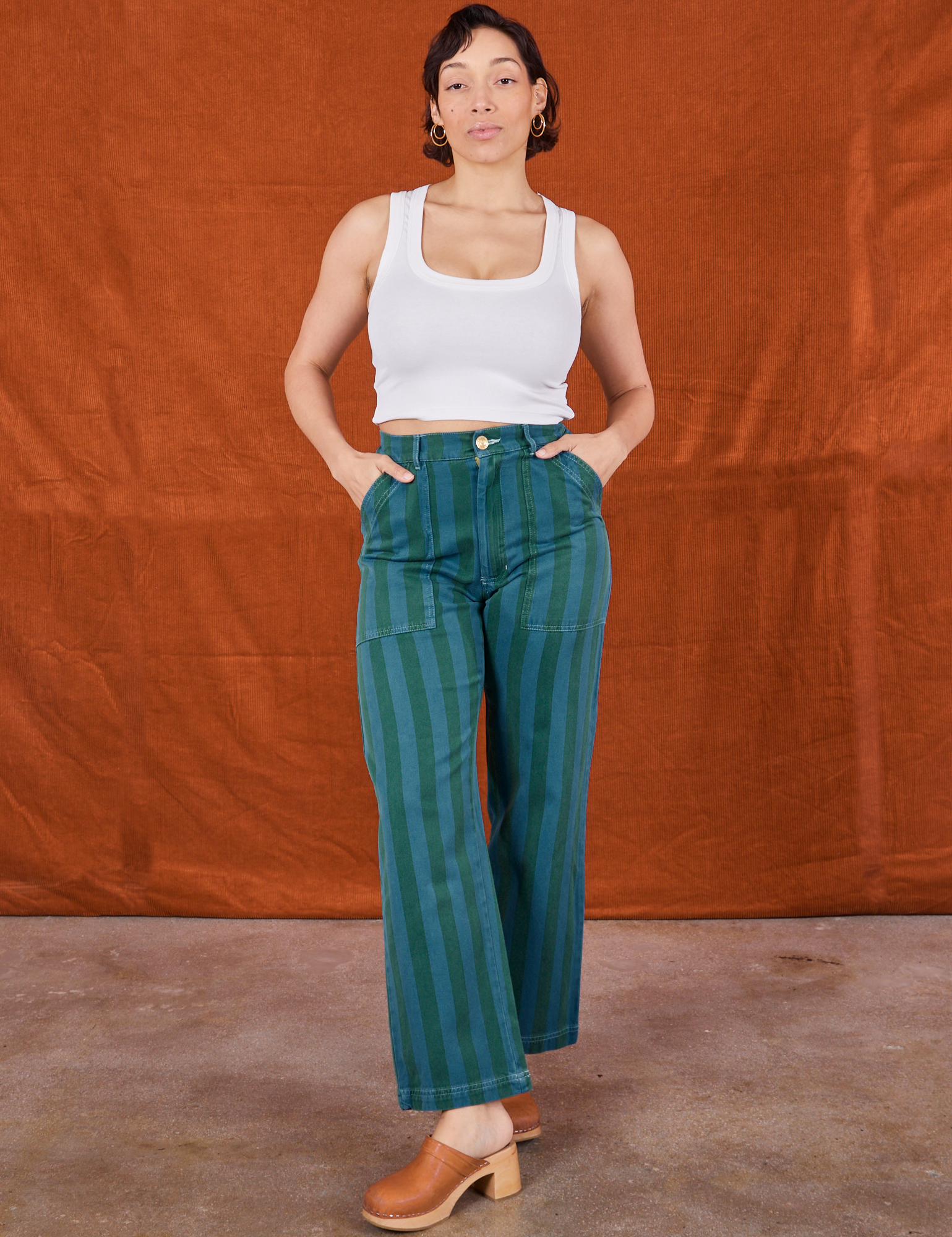 Tiara is wearing Overdye Stripe Work Pants in Blue/Green and Cropped Tank Top in vintage tee off-white