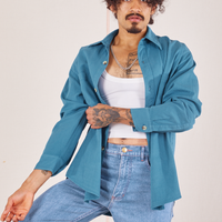 Jesse is wearing Oversize Overshirt in Marine Blue with a vintage off-white Cropped Tank Top underneath
