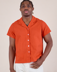 Isaac is 5'10" and wearing M Button-Up in Chili Red
