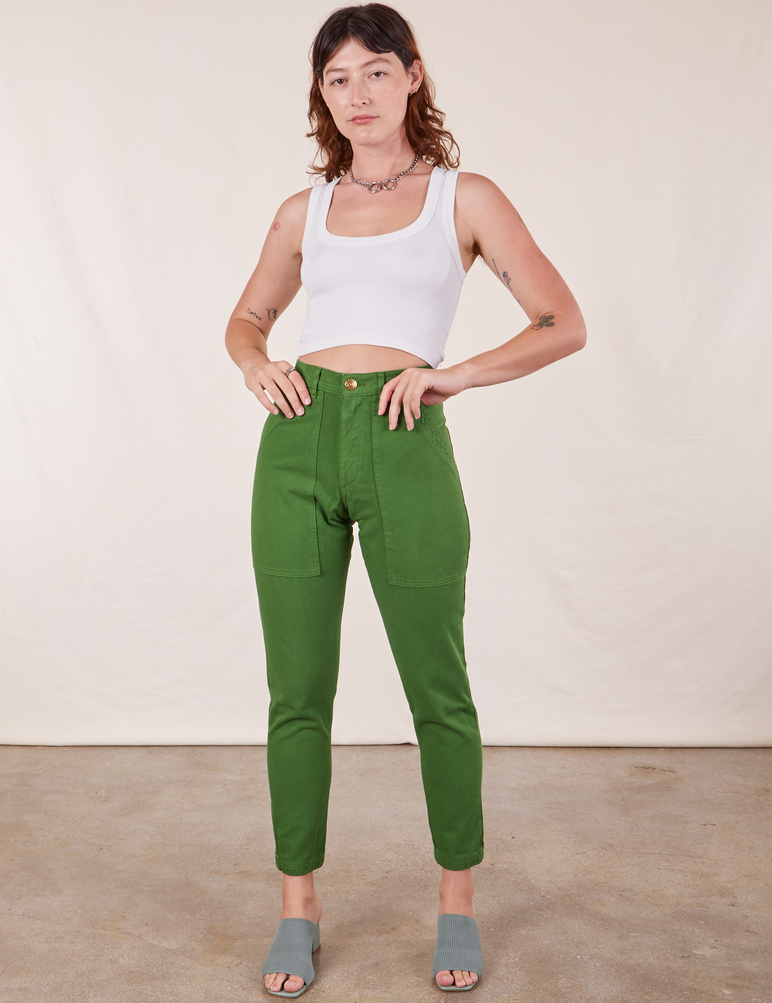 Alex is wearing Pencil Pants in Lawn Green and vintage off-white Cropped Tank Top