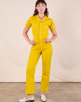 Alex is 5'8" and wearing XXS Short Sleeve Jumpsuit in Golden Yellow