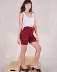 Angled front view of Railroad Carpenter Shorts in Mustang Red and Cropped Tank in Vintage Tee Off-White on Alex