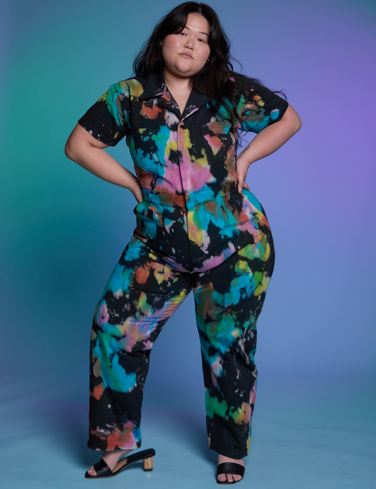 Ashley is wearing Short Sleeve Jumpsuit in Rainbow Magic Waters
