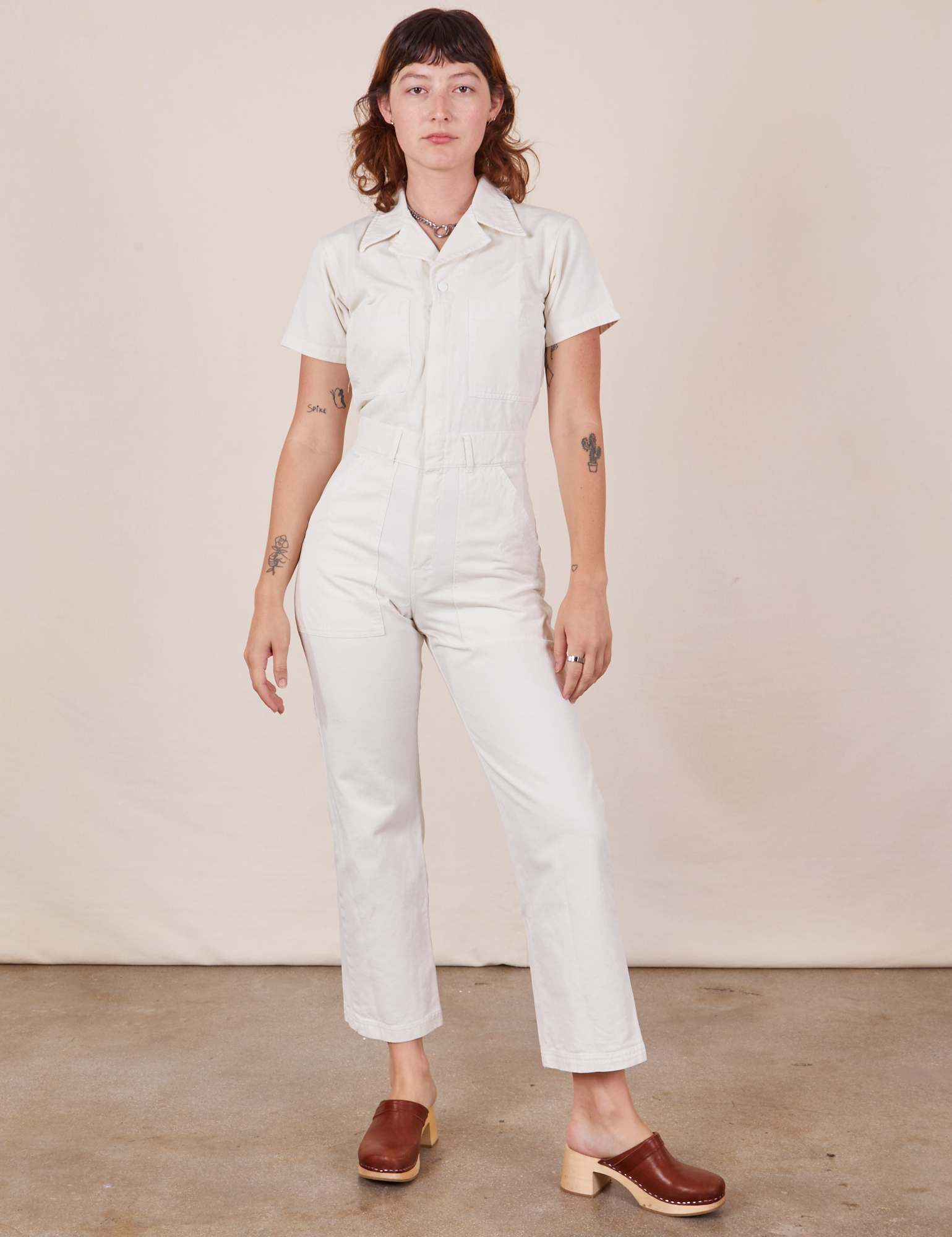Alex is 5&#39;8&quot; and wearing XS Short Sleeve Jumpsuit in Vintage Tee Off-White