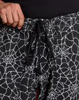 Drop Pocket Cargo Pants in Spider Webs close up of front black drawstring