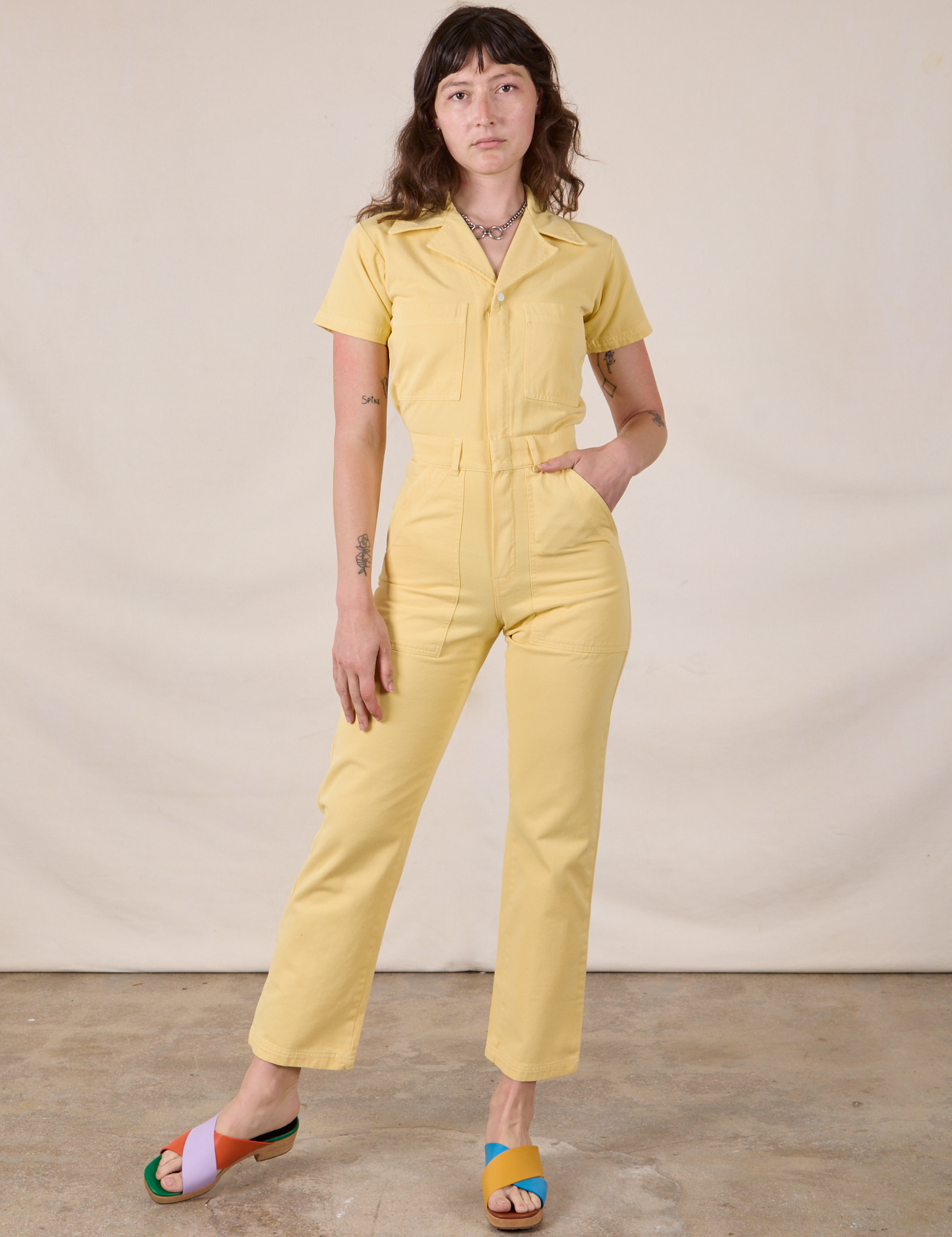 Alex is 5'8" and wearing XXS Short Sleeve Jumpsuit in Butter Yellow