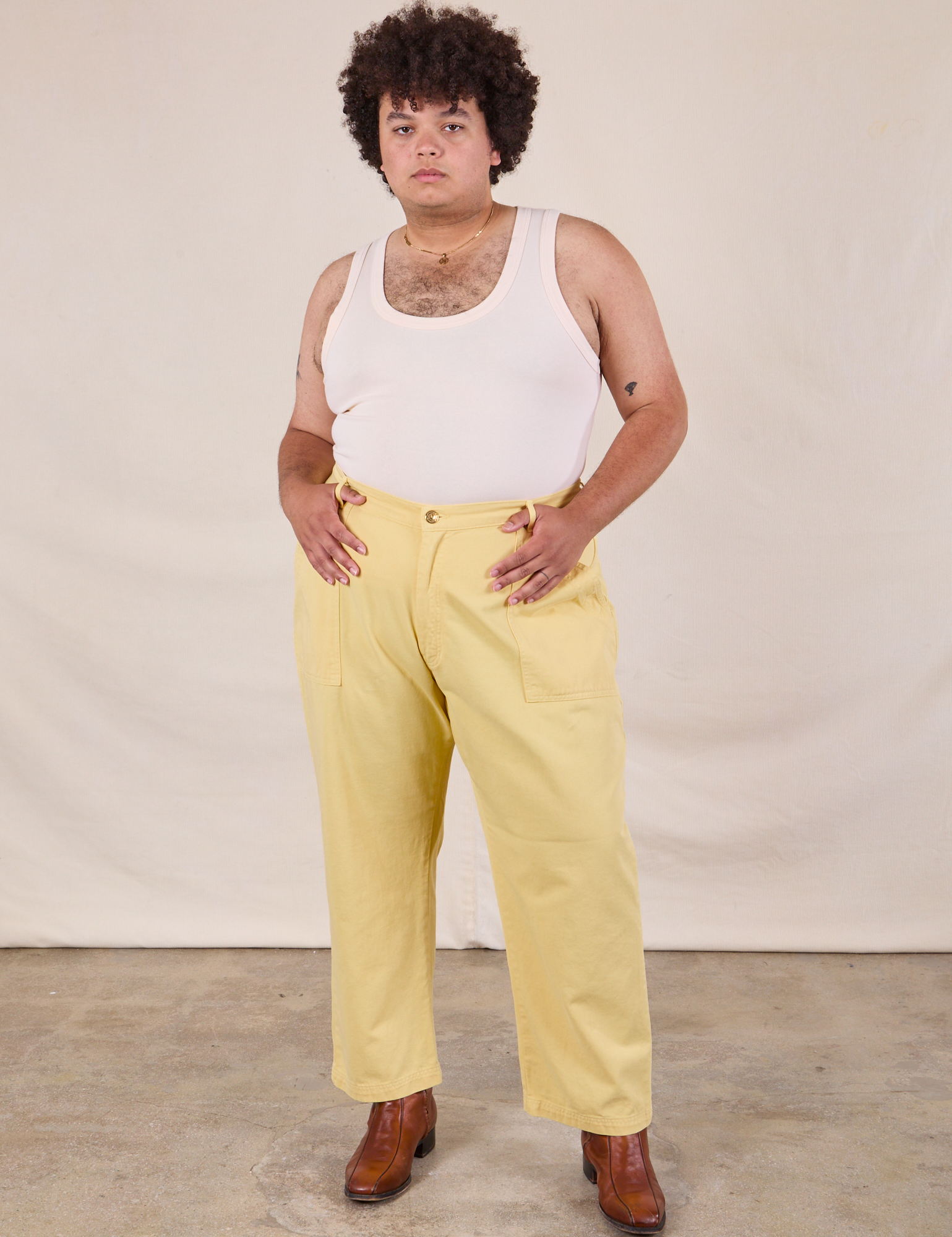 Work Pants in Butter Yellow and Tank Top in vintage tee off-white on Miguel