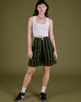 Alex is wearing Longline Work Shorts in Evergreen and Cropped Tank in Vintage Tee White