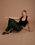 Tiara is wearing Black Stripe Work Pants in Evergreen