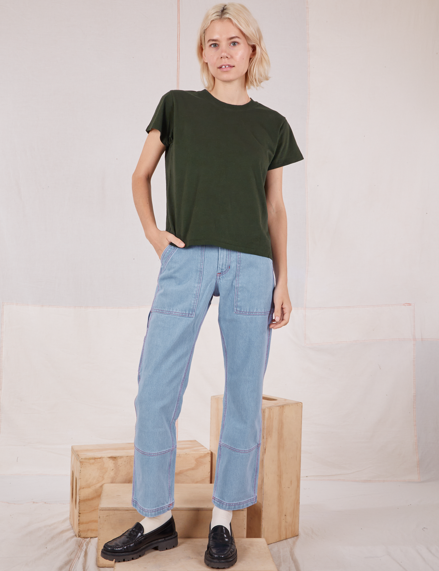 Madeline is wearing Organic Vintage Tee in Swamp Green and light wash Carpenter Jeans