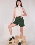 Trouser Shorts in Swamp Green and Sleeveless Turtleneck in Vintage Tee Off-White on Alex