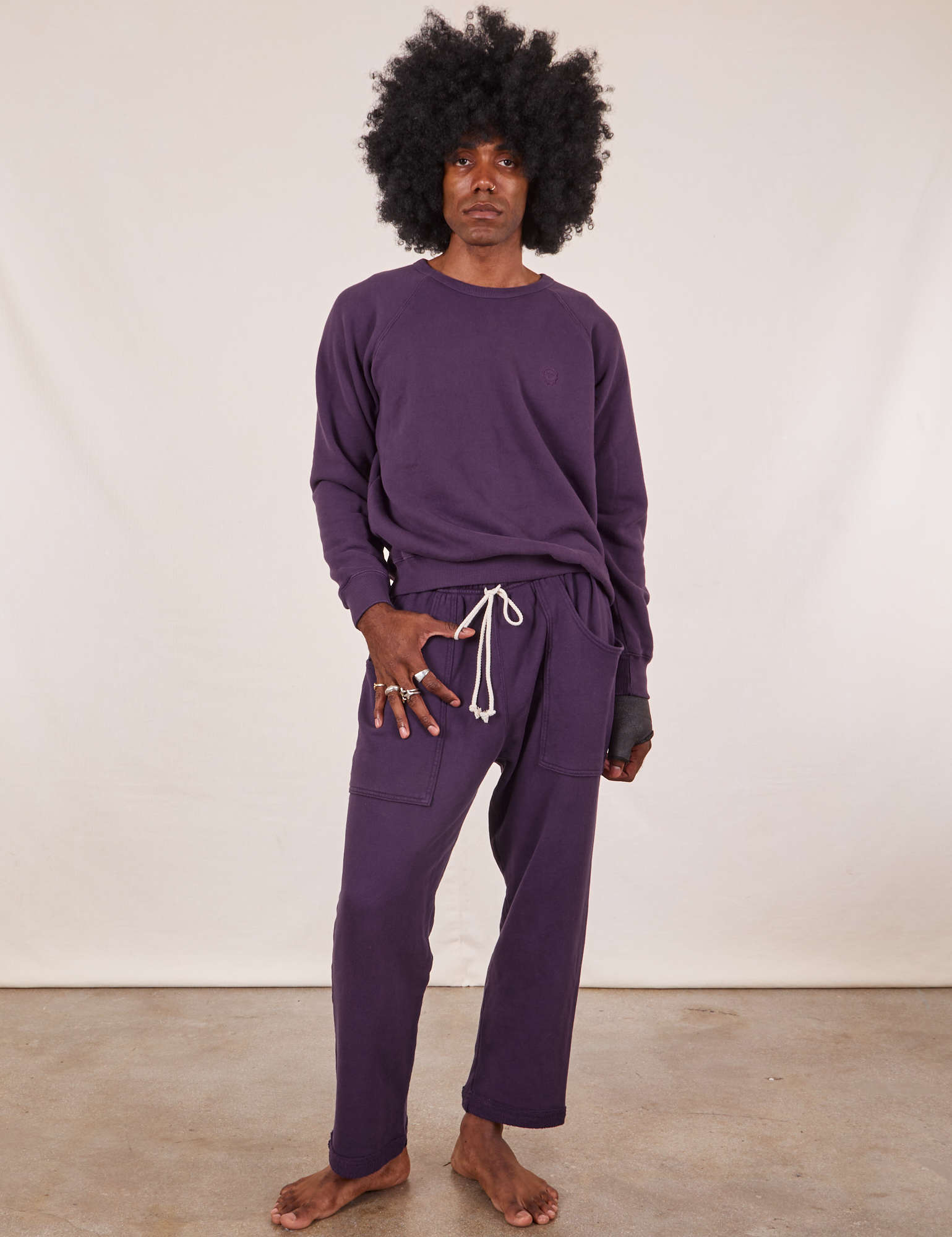 Jerrod is wearing Heavyweight Crew in Nebula Purple and Cropped Rolled Cuff Sweatpants