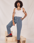 Jesse is wearing Denim Trouser Jeans in Railroad Stripe and Tank Top in vintage tee off-white