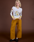 Madeline is wearing Floral Long Sleeve Baby Tee in Yellow and spicy mustard Drop Pocket Cargo Pants