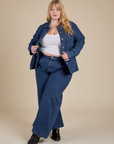 Juliet is wearing Indigo Denim Work Jacket in Dark Wash and dark wash Indigo Wide Leg Trousers