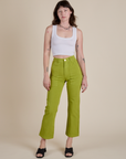 Alex is wearing Work Pants in Gross Green and vintage tee white Cropped Tank