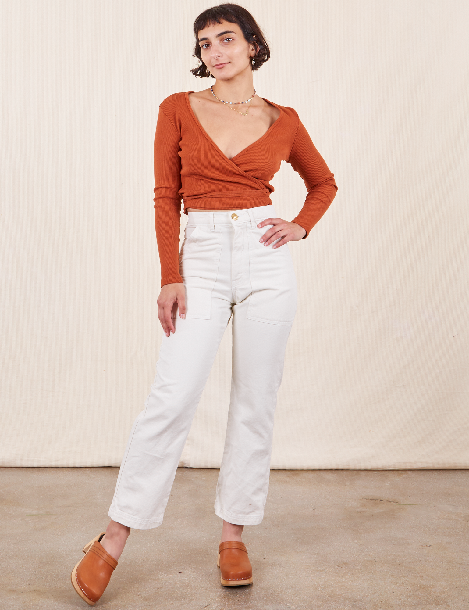 Soraya is 5&#39;2&quot; and wearing Petite XXS Work Pants in Vintage Off-White paired with burnt terracotta Wrap Top