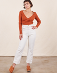 Soraya is 5'2" and wearing Petite XXS Work Pants in Vintage Off-White paired with burnt terracotta Wrap Top