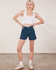 Madeline is 5’9” and wearing XXS Classic Work Shorts in Lagoon paired with a Cropped Tank Top in vintage tee off-white