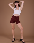 Alex is 5’8” and wearing XXS Classic Work Shorts in Red Wine paired with vintage tee white Cropped Tank