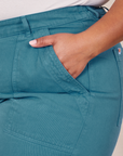 Classic Work Shorts in Marine Blue front pocket close up. Morgan has her hand in the pocket.