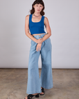 Alex is wearing Cropped Tank Top in Royal Blue and light wash Indigo Wide Leg Trousers