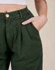 Close up of Alex's hand in the front pocket of Heavyweight Trousers in Swamp Green