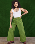 Jesse is wearing Overdyed Wide Leg Trousers in Gross Green and Cropped Tank Top in vintage tee off-white