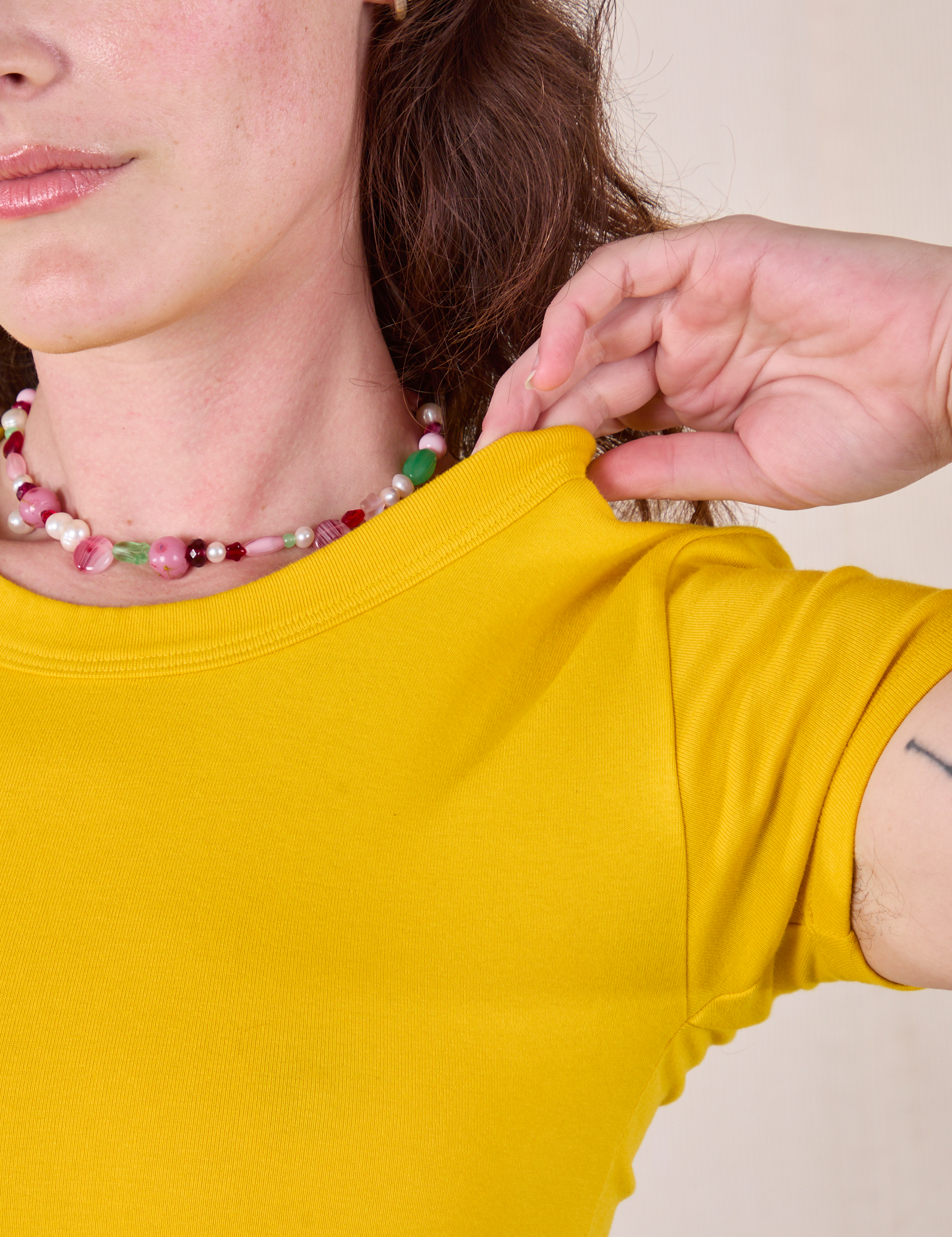 Neckline close up Baby Tee in Golden Yellow on Alex