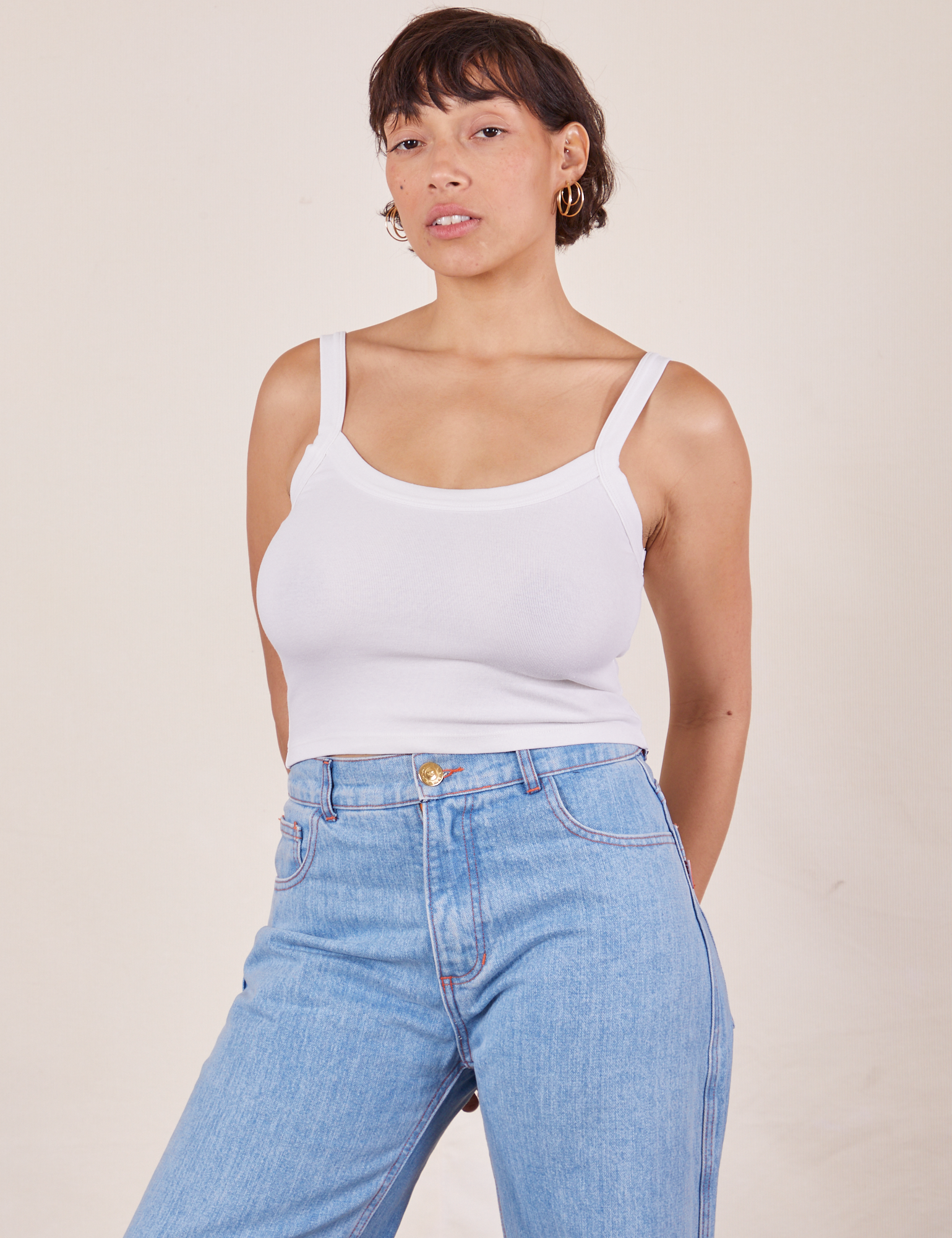 Tiara is wearing Cropped Cami in Vintage Tee Off-White and light wash Sailor Jeans