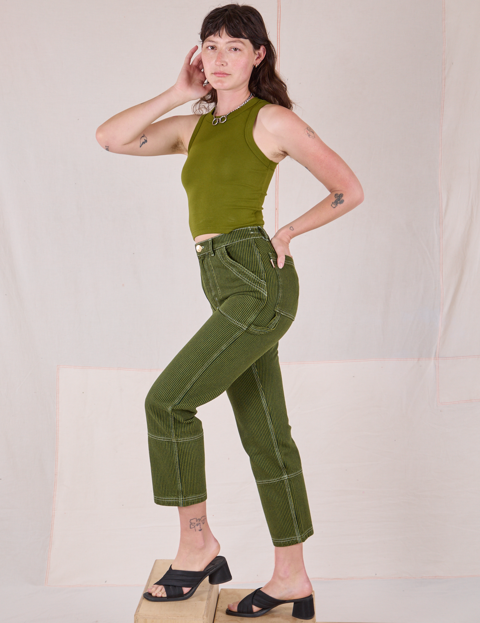 Side view of Railroad Carpenter Jeans in Summer Olive and Muscle Tee on Alex