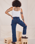 Back view of Carpenter Jeans in Dark Wash and Cropped Cami in vintage tee off-white worn by Jesse