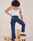 Back view of Carpenter Jeans in Dark Wash and vintage off-white Cami worn by Jesse