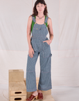 Alex is wearing Carpenter Overalls in Railroad