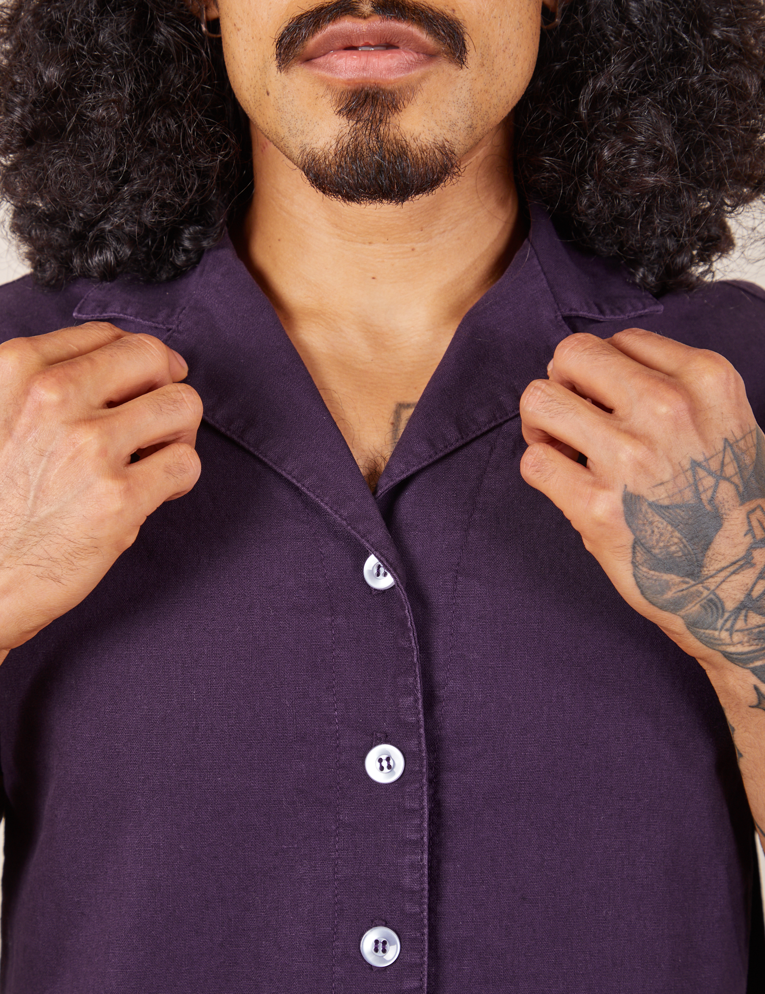 Front close up of Pantry Button-Up in Nebula Purple. Jesse is holding the collar.